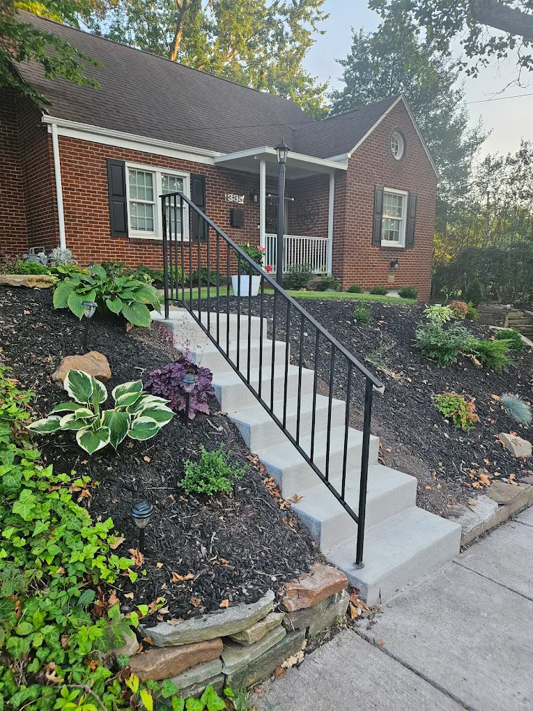 Front walkway stair railing at brick home