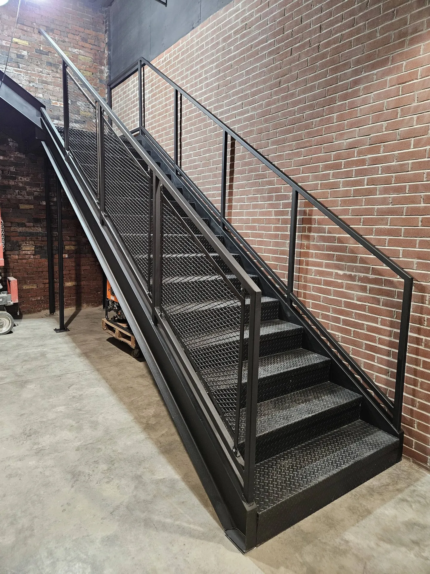 Custom fabricated steel staircase with mesh panels